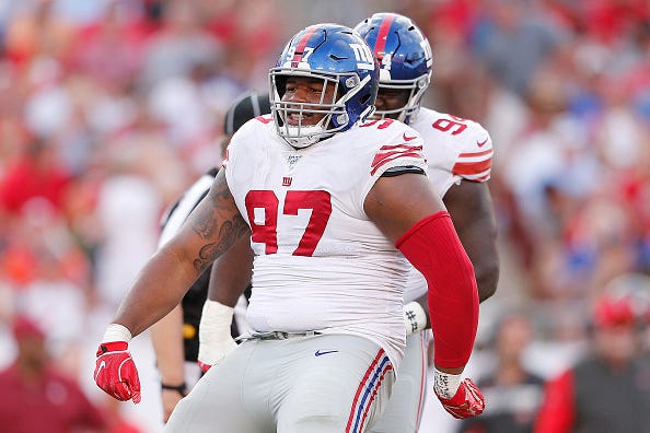 Dexter Lawrence models the Giants white uniform tops. 