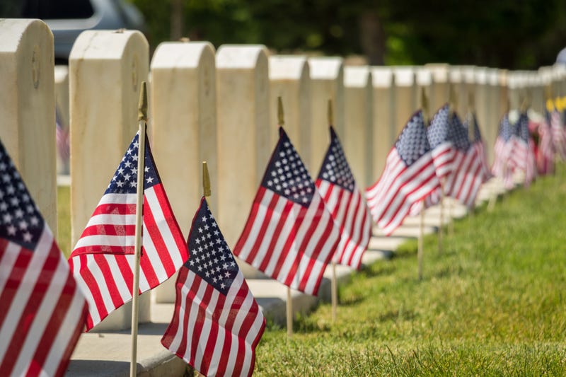Military headstones decorated with American flags.