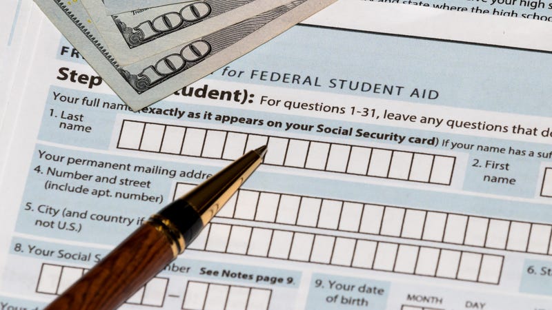 Student aid form with a pen and a couple hundred dollar bills