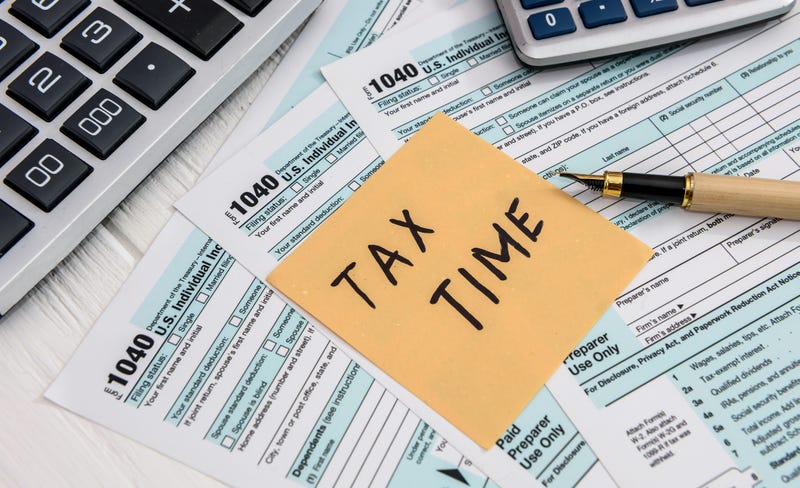 'Tax time' memo on 1040 individual tax form - stock photo