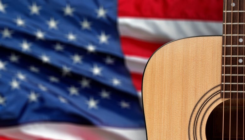 Acoustic guitar close up on american flag background