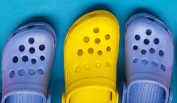 Row of Crocs against blue background