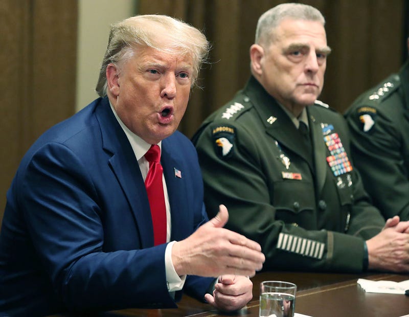 U.S. President Donald Trump speaks as Joint Chiefs of Staff Chairman, Army General Mark Milley looks on after a briefing from senior military leaders in the Cabinet Room at the White House on October 7, 2019 in Washington, DC. Trump spoke about the pull-out of U.S troops in northeastern Syria and the impeachment inquiry in the House of Representatives.