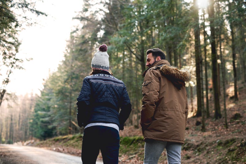 Father and son hiking in autumn forest