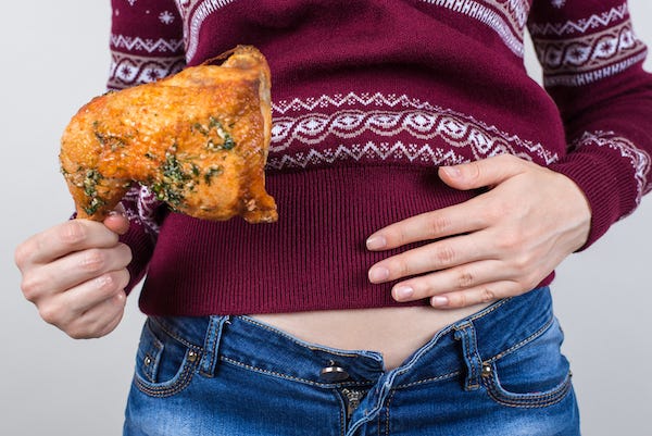 Woman full from eating turkey
