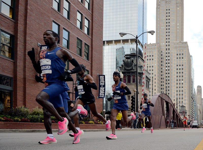 Bedan Karoki of Kenya runs in front of Dejene Debela of Ethiopia, Seifu Tura of Ethiopian, and Lawrence Cherono of Kenya during the 2019 Bank of America Chicago Marathon on October 13, 2019 in Chicago, Illinois.