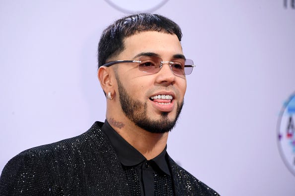 singer Anuel AA smiling wearing dimonds on his teeth