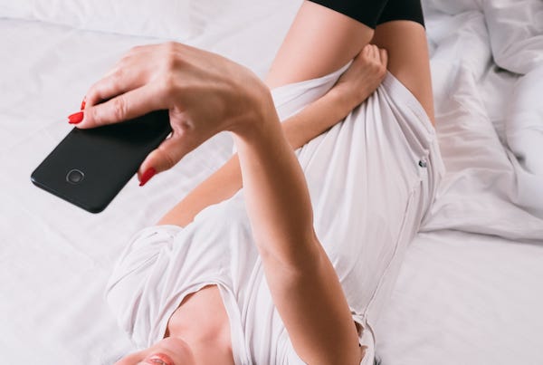 Woman taking sexy selfies in bed