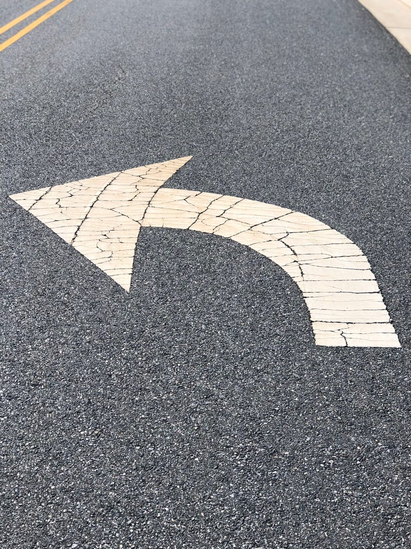 Left turn arrow on road