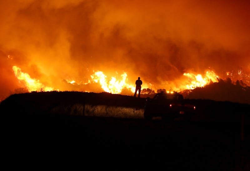 A CAL FIRE firefighter monitors the Kincaide Fire as it burns a hillside on October 24, 2019 in Geyserville, California.