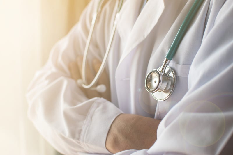 Physician standing with his arms crossed. 