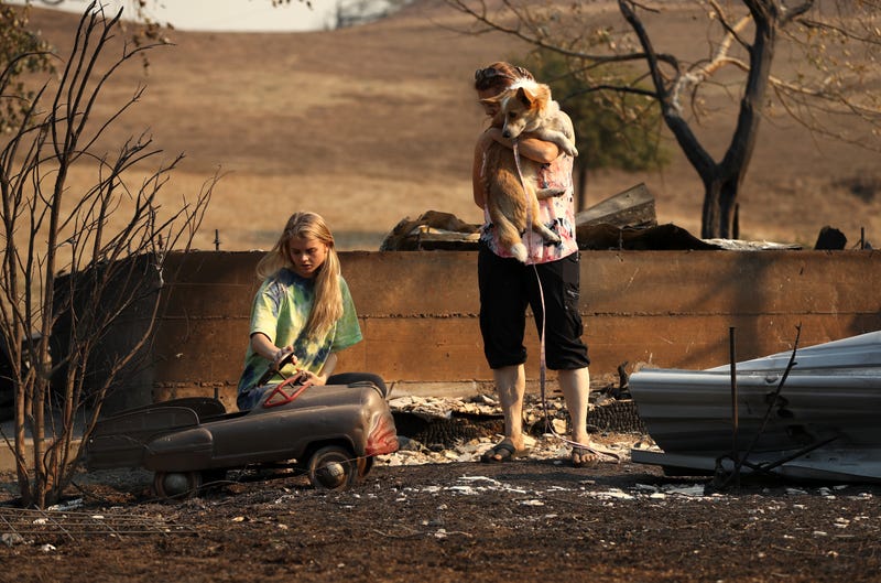 Ashley LaFranchi (L) and Stephanie LaFranchi (R) walk through a family home that was destroyed by the Kincade Fire on October 28, 2019 in Calistoga, California.