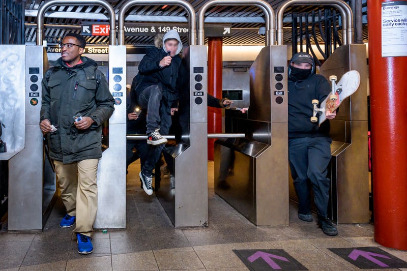 Protesters jumping the turnstile at a subway station