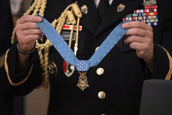 A military aide holds U.S. Army Master Sgt. Matthew Williams' Medal of Honor during a ceremony in the East Room of the White House October 30, 2019 in Washington, DC.