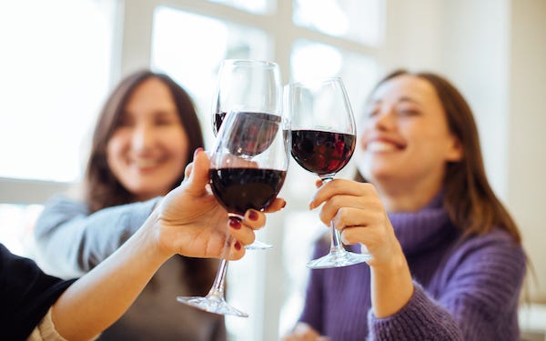 Women toasting red wine