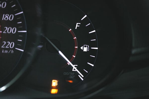 Fuel gauge showing low fuel on dashboard