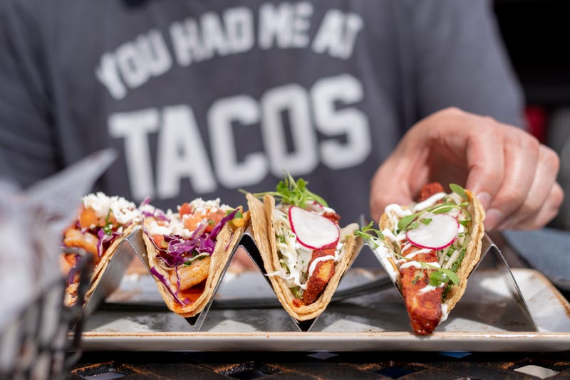 closeup of man eating tacos