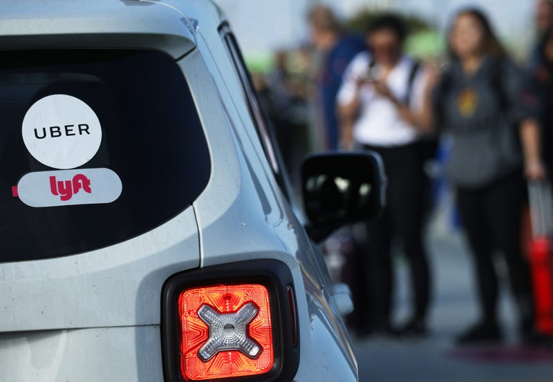 Arriving passengers wait to board Uber vehicles at the new 'LAX-it' ride-hail passenger pickup lot at Los Angeles International Airport (LAX) on November 6, 2019 in Los Angeles, California.