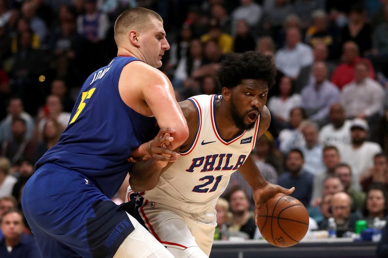DENVER, COLORADO - NOVEMBER 08: Nikola Jokic #15 of the Denver Nuggets guards Joel Embiid #21 of the Philadelphia 76ers in the fourth quarter at the Pepsi Center on November 08, 2019 in Denver, Colorado. 
