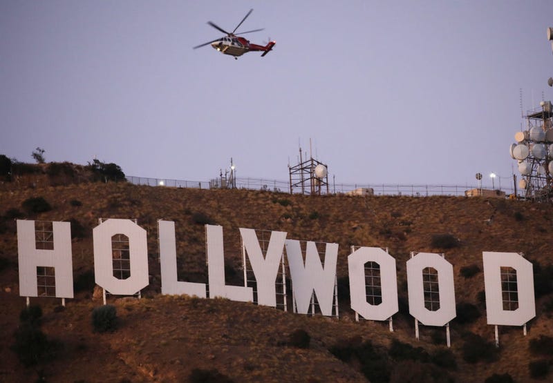 A firefighting helicopter flies near the Hollywood sign as the Barham fire burns nearby on November 09, 2019 in Los Angeles, California. The brush fire has burned roughly 34 acres of vegetation and appears to be under control. (Photo by Mario Tama/Getty Images)