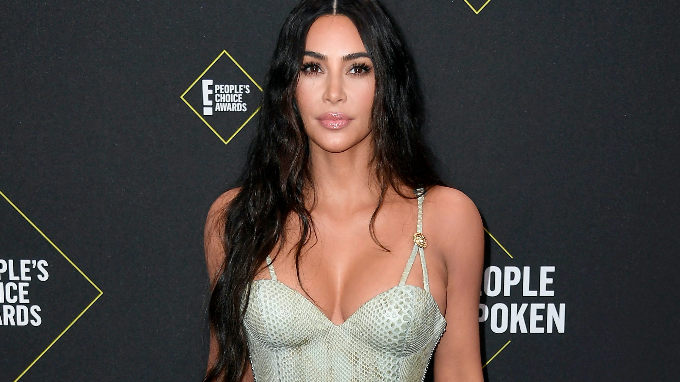 Kim Kardashian sizzles in the desert wearing a purple string bikini
