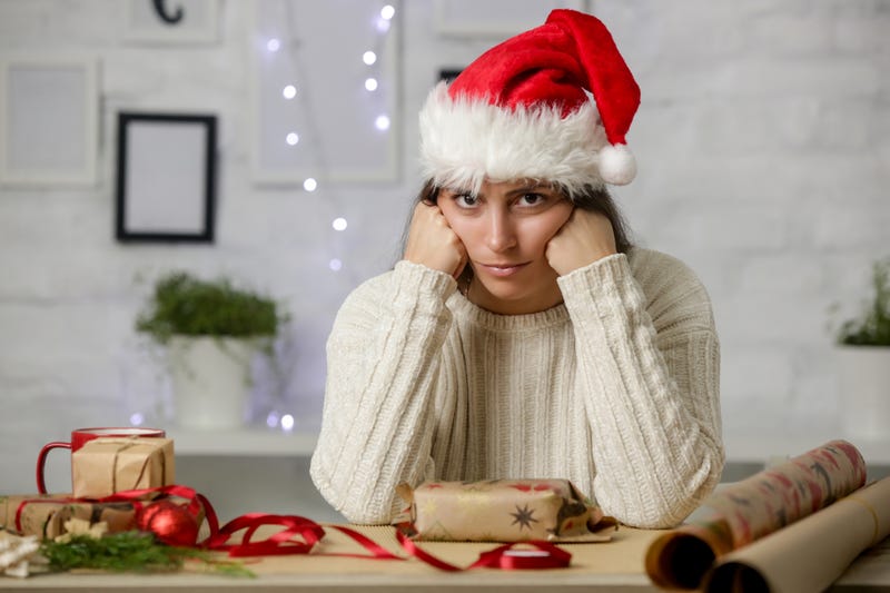 upset woman wearing Santa hat
