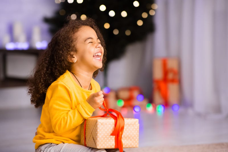Girl laughing with holiday gift