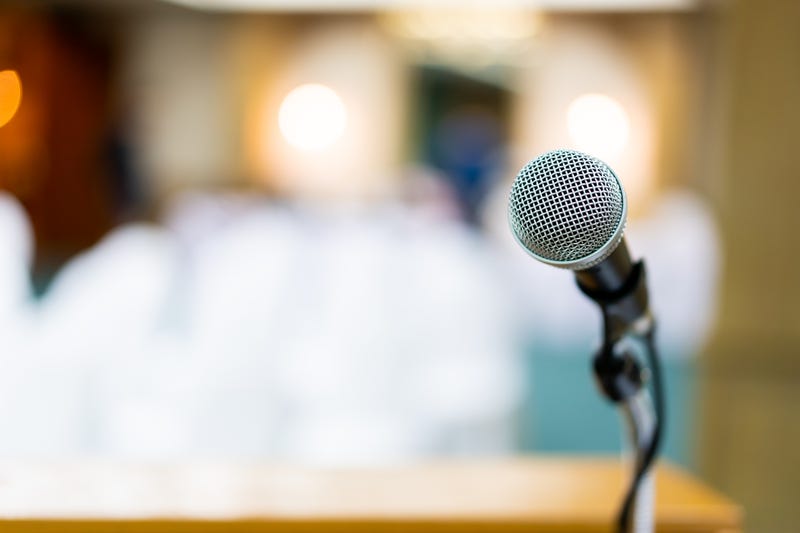 Wired microphone set up on the front of conference room close up with blurred background