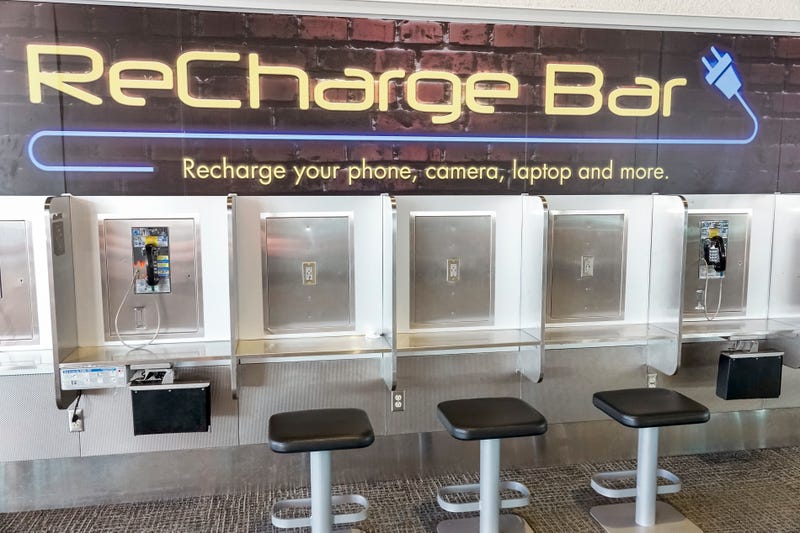 Electronics-recharging station (repurposed pay phone bank) at Miami International Airport.