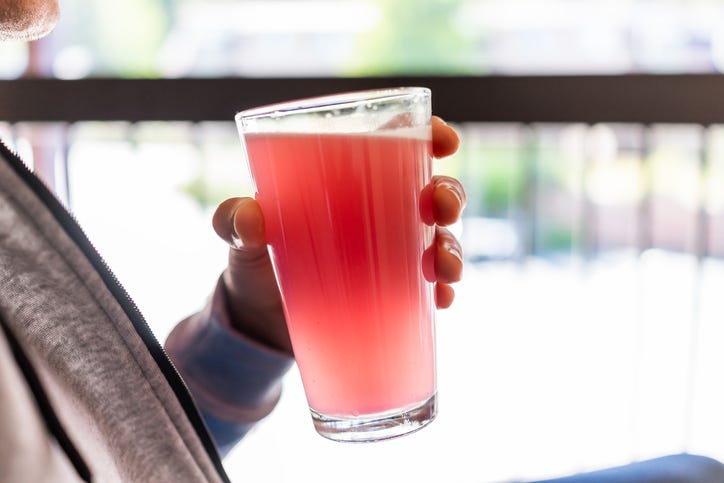 man drinking strawberry tea