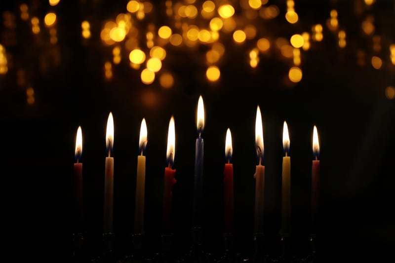 A menorah with all of its candles lit. 