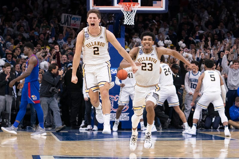 Collin Gillespie #2 and Jermaine Samuels #23 of the Villanova Wildcats react after defeating the Kansas Jayhawks at the Wells Fargo Center on December 21, 2019 in Philadelphia, Pennsylvania. The Villanova Wildcats defeated the Kansas Jayhawks 56-55.