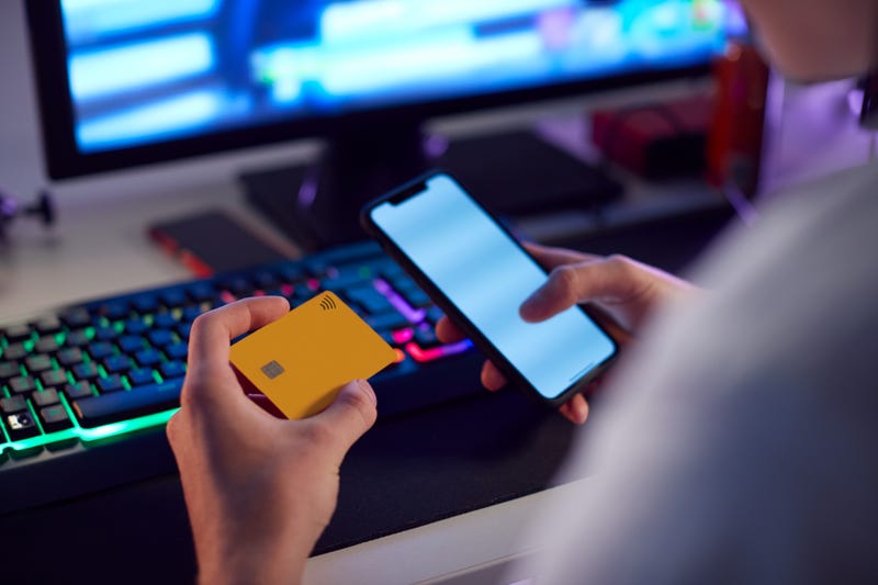 Person using credit card and phone