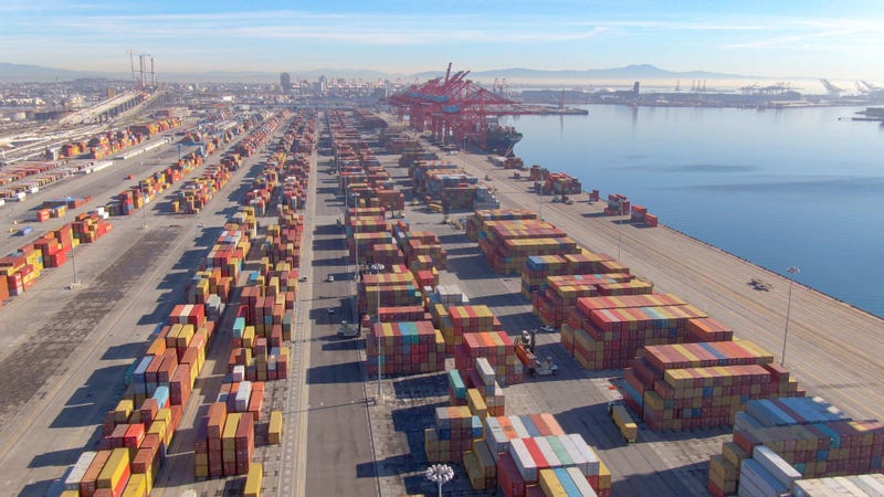 DRONE Stacks of colorful freight containers stretch far out into the distance in the Port of Los Angeles
