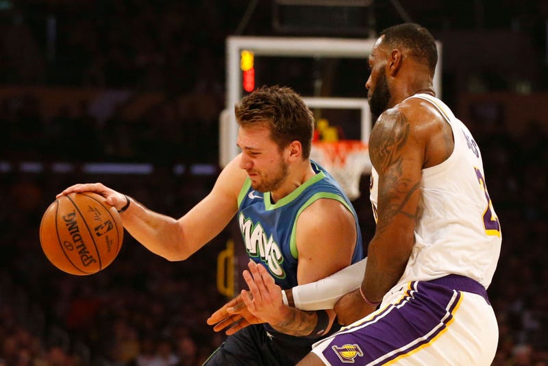 Luka Doncic #77 of the Dallas Mavericks drives around LeBron James #23 of the Los Angeles Lakers during the first half at Staples Center on December 01, 2019 in Los Angeles, California.