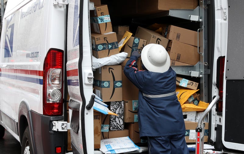 A U.S. Postal Service (U.S.P.S.) worker unpacks packages from a truck on December 02, 2019 in San Francisco, California.