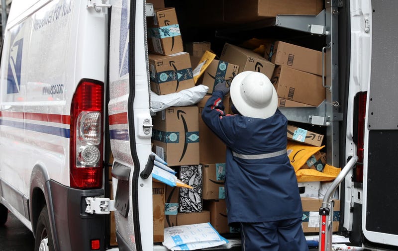 A U.S. Postal Service (U.S.P.S.) worker unpacks packages from a truck on December 02, 2019 in San Francisco, California.