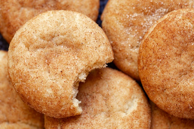 Overhead view of homemade snickerdoodle cookies with a bite missing
