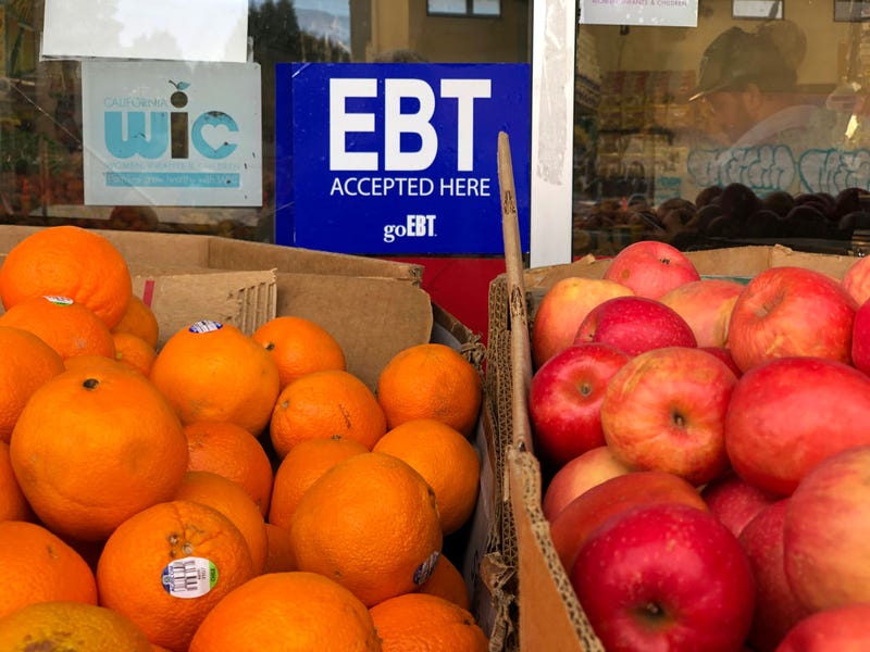 A sign noting the acceptance of electronic benefit transfer (EBT) cards that are used by state welfare departments to issue benefits is displayed at a grocery store on December 04, 2019 in Oakland, California.