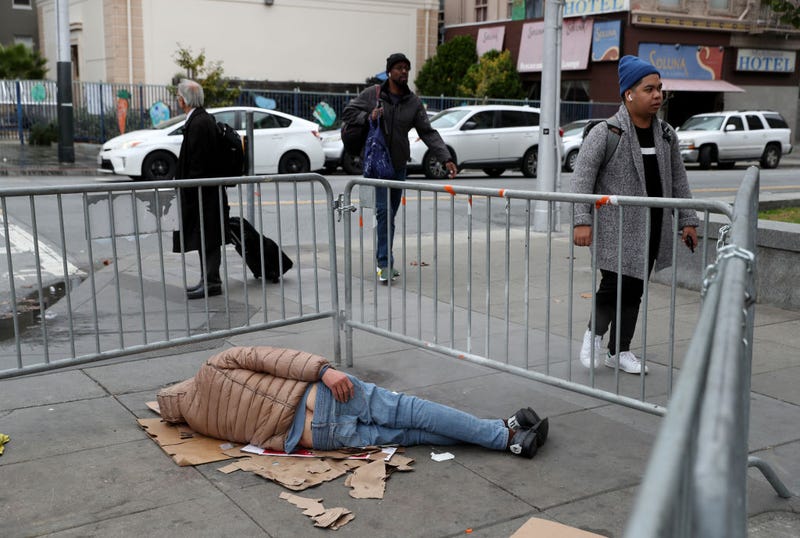 A homeless man sleeps on the sidewalk on December 05, 2019 in San Francisco, California.