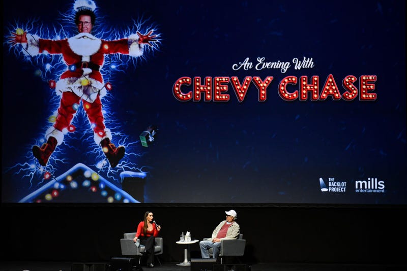  Chevy Chase speaks with moderator Yenitza Munoz during a Q&A session following a special screening of "National Lampoon's Christmas Vacation"