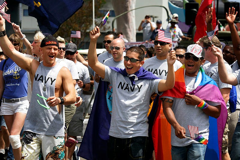 Military personnel march down University Avenue during the San Diego gay pride parade.