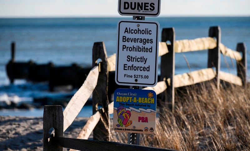 A sign warning of consuming alcoholic beverages is seen on the boardwalk in Ocean City, New Jersey
