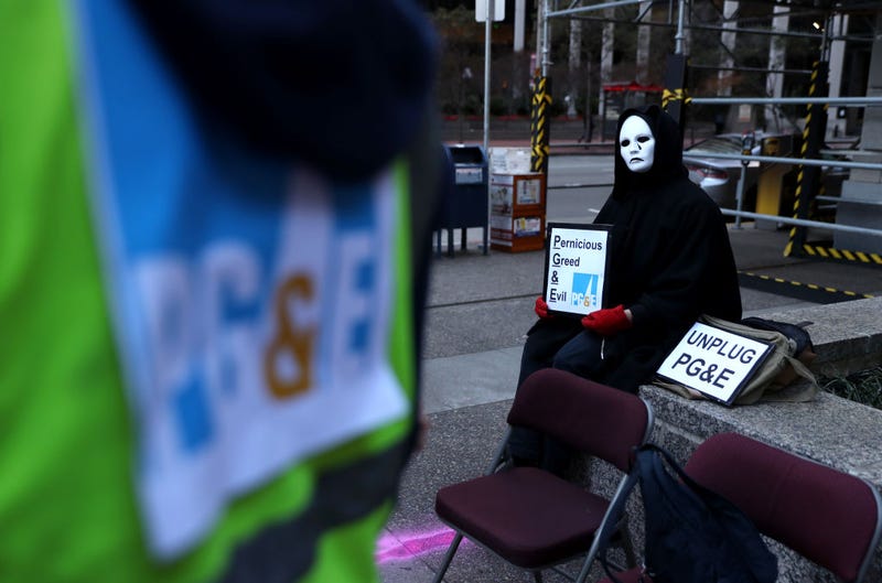 A protester holds a sign during demonstration outside of Pacific Gas and Electric (PG&E) on December 16, 2019 in San Francisco, California. 