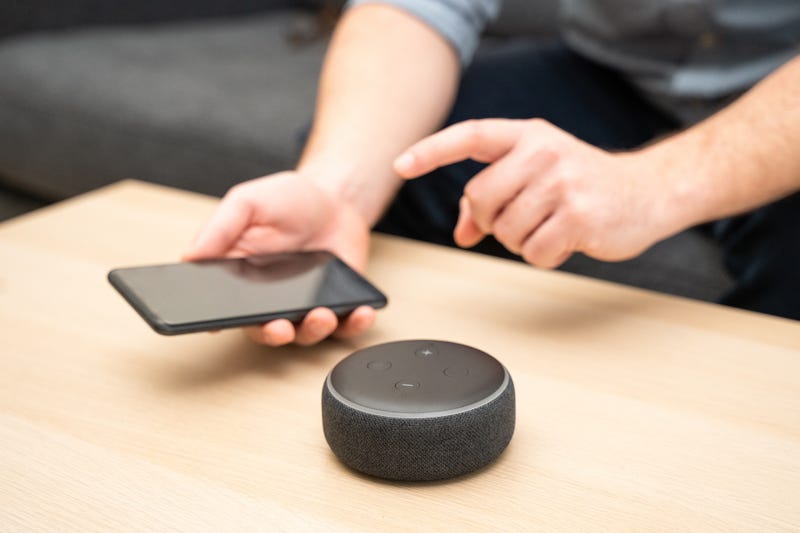 Man using home assistant Bluetooth speaker.