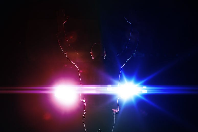 Silhouette of man getting arrested