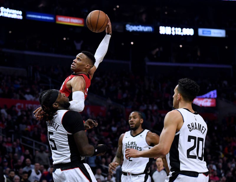 Russell Westbrook attempts a dunk over Montrezl Harrell of the Clippers.