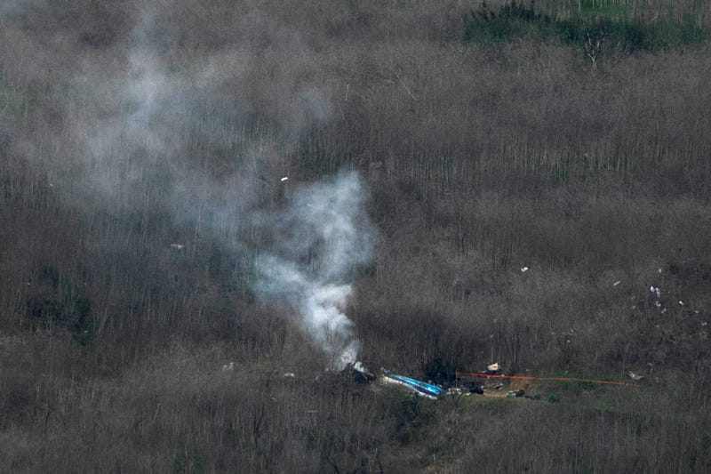 Wreckage of the crashed helicopter that was carrying former NBA star Kobe Bryant and his 13-year-old daughter Gianna smolders on the ground on January 26, 2020 in Calabasas, California. 