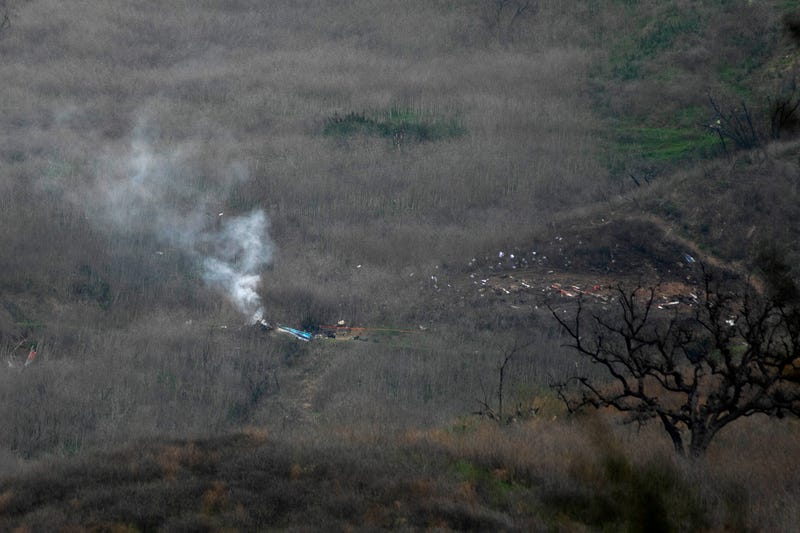  Wreckage of the crashed helicopter that was carrying former NBA star Kobe Bryant and his 13-year-old daughter Gianna smolders on the ground on January 26, 2020 in Calabasas, California.