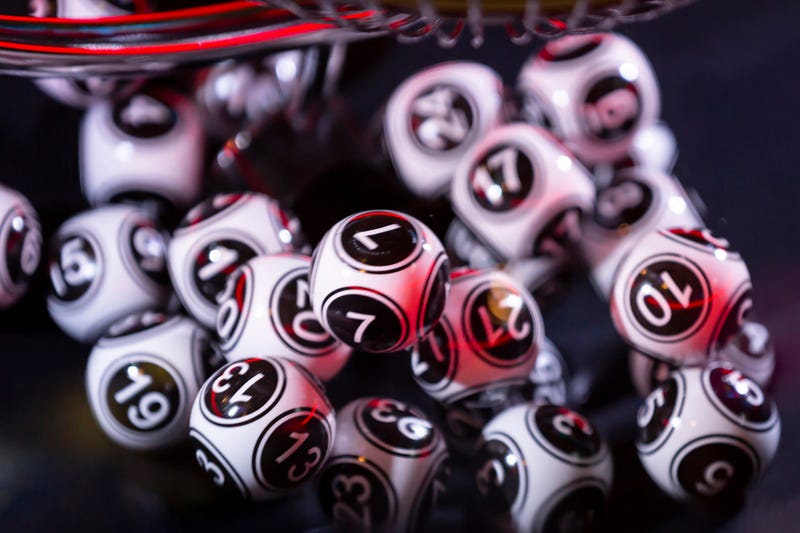 Black and white lottery balls in a bingo machine. Lottery balls in a sphere in motion. Gambling machine and euqipment. Blurred lottery balls in a lotto machine. Number 7.